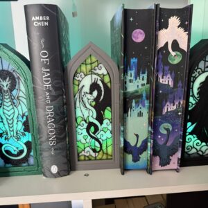 Illuminated gothic arched book nooks arranged beside a row of books